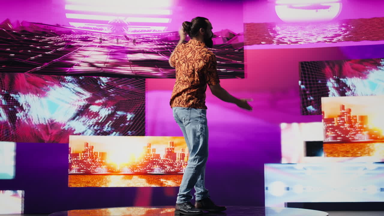 Young carefree guy performing with fun dance moves in glowing neon ambiance
