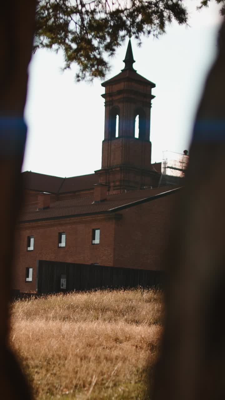 Brick Building with Tower and Field
