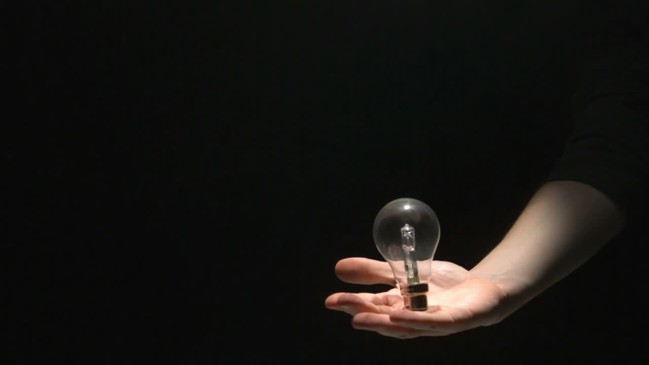 손으로 전구를 잡는 남자