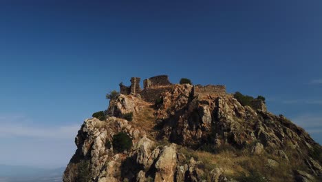 old ruins of a destroyed castle on top of a mountain