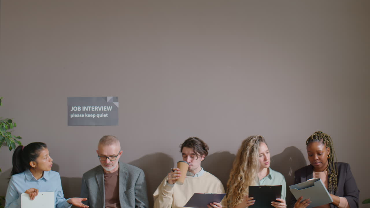 Job Candidates Chatting and Drinking Coffee in Queue