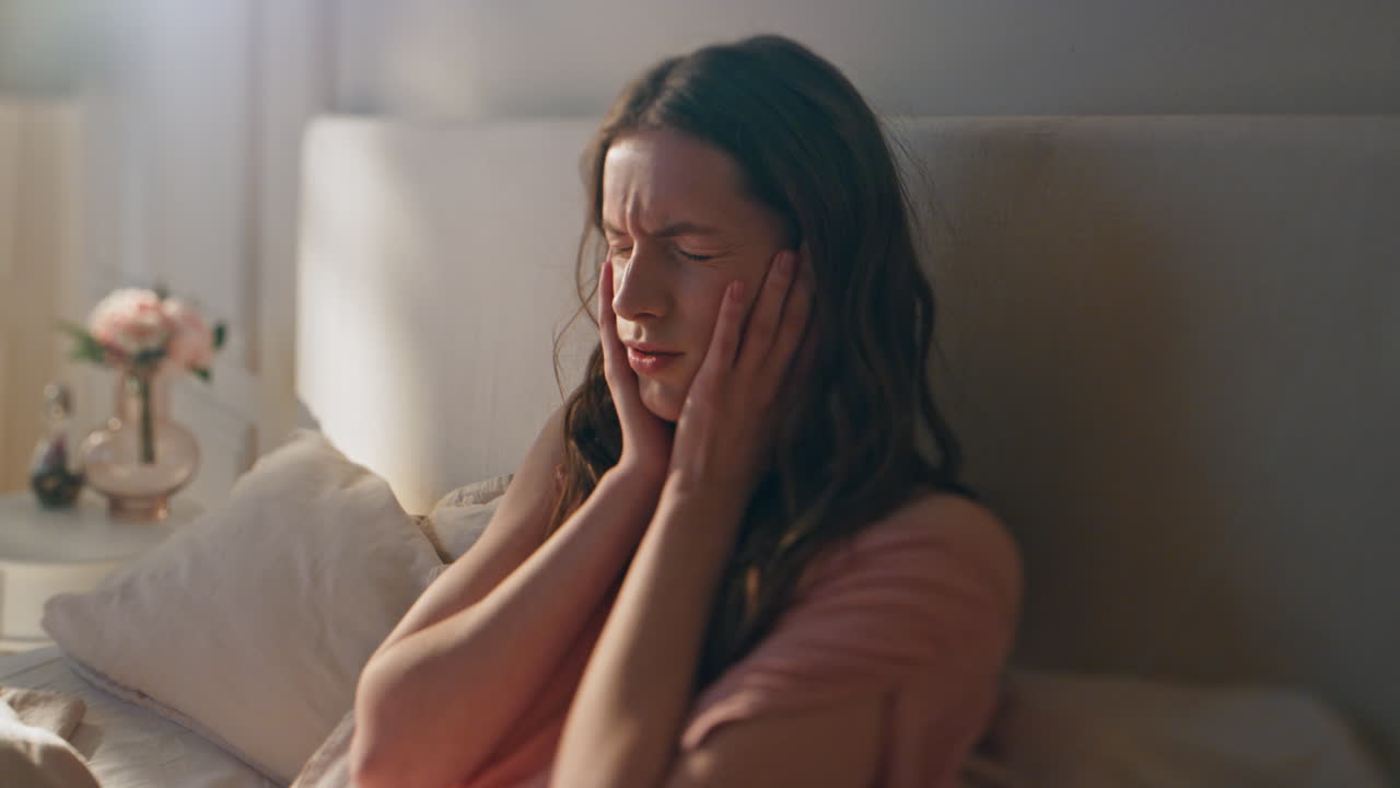 Dizzy girl feeling headache in morning closeup. Frustrated woman suffer hangover