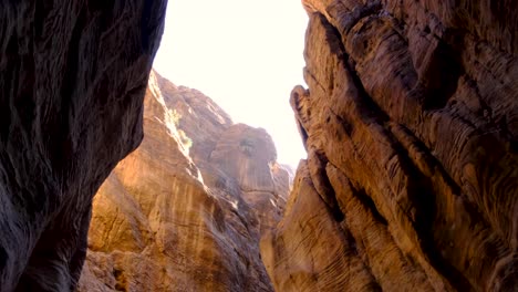 Exploring-the-rugged,-rocky-and-tall-valley-walls-of-Wadi-Ghuweir-canyon-in-the-remote-wilderness-of-Jordan,-Middle-East