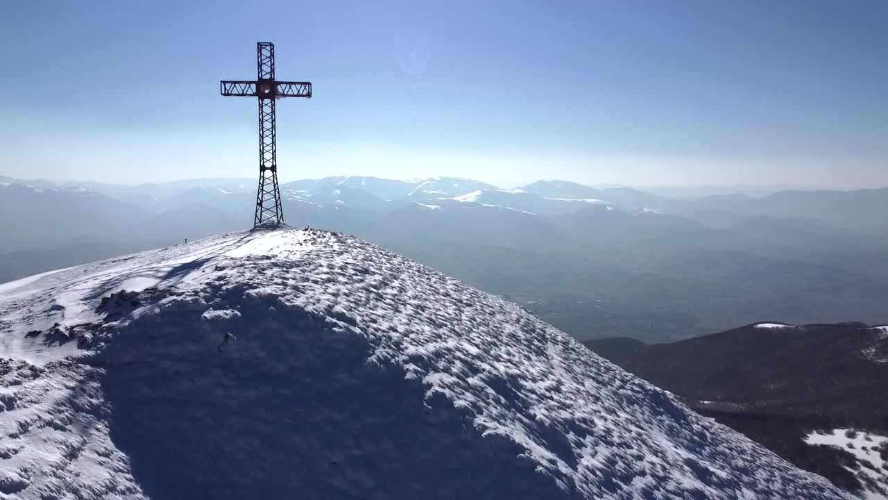 Aerial mountains landscape snow covered alps peak with iron cross, drone reveals stunning winter landscape extreme alpine trekking hiking expedition