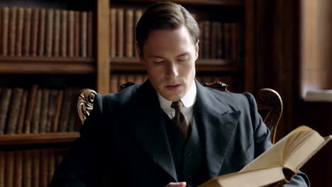 a man in a suit reading a book in a classic library