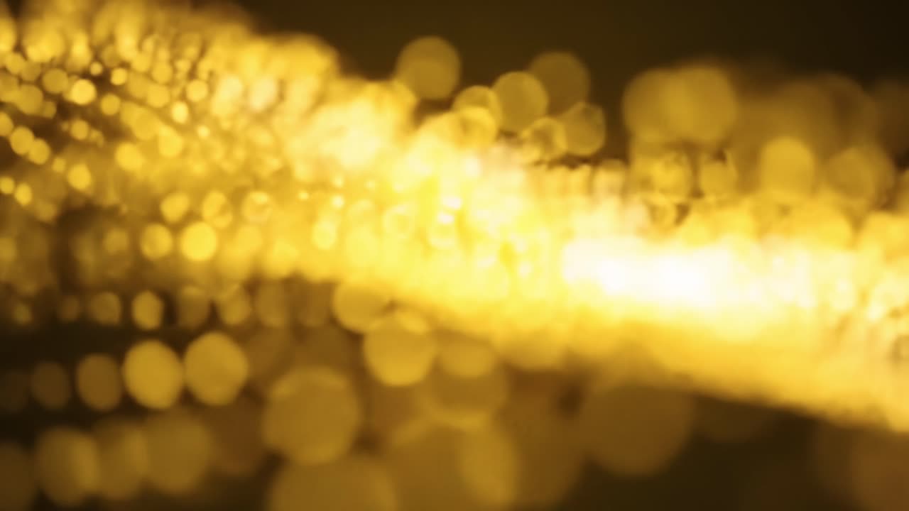 This captivating display features shimmering golden lights forming intricate patterns. The glowing visuals create a serene ambiance, perfect for relaxation or contemplation during evening hours.