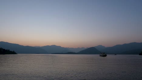 ferry on lake at dusk in italy