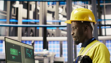 vertical video smart factory employee typing on pc keyboard, testing automated systems
