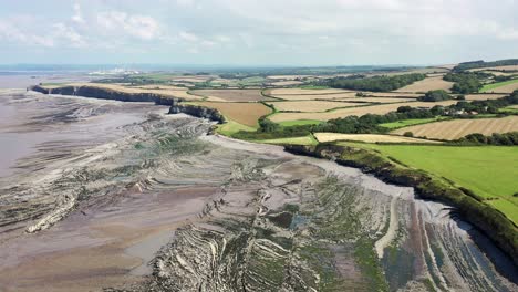 Drone-shot-while-moving-right-to-left-over-Kilve-beach-and-its-sea-cliffs-in-North-Devon,-UK