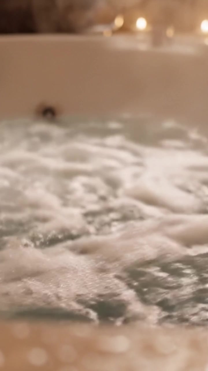 Relaxing Soak in a Bubbling Hot Tub: A Tranquil Retreat for Self-Care and Rejuvenation with Luxurious Foam and Crystal-clear Water