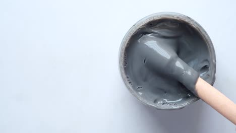 grey clay face mask in a glass jar