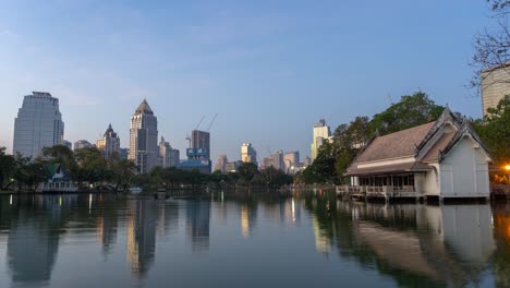 cityscape at dusk with park and lake reflection