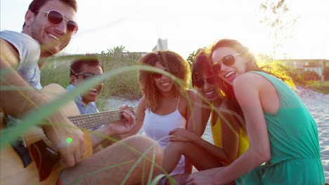 portrait of multi ethnic friends playing the guitar