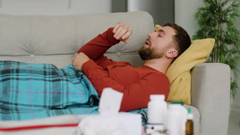 sick man laying on the sofa