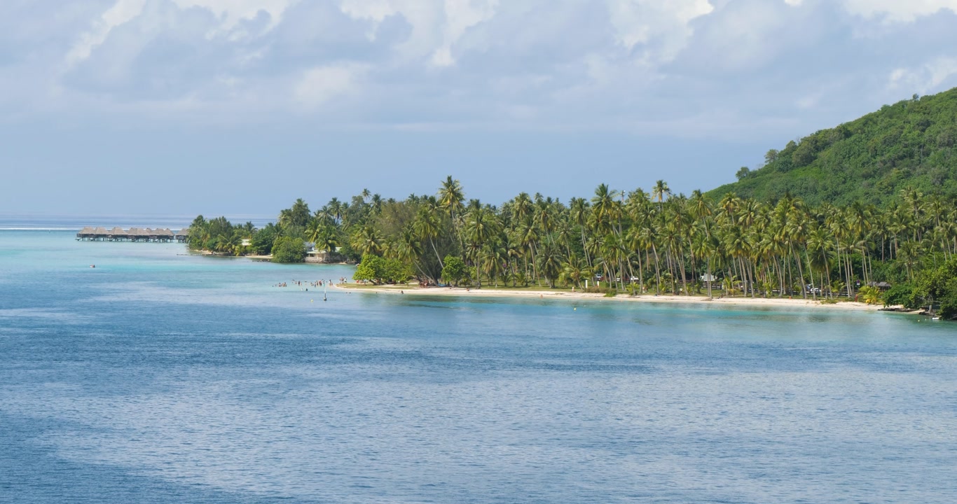 Small public beach in Moorea, French Polynesia.Overwater wooden bungalows..