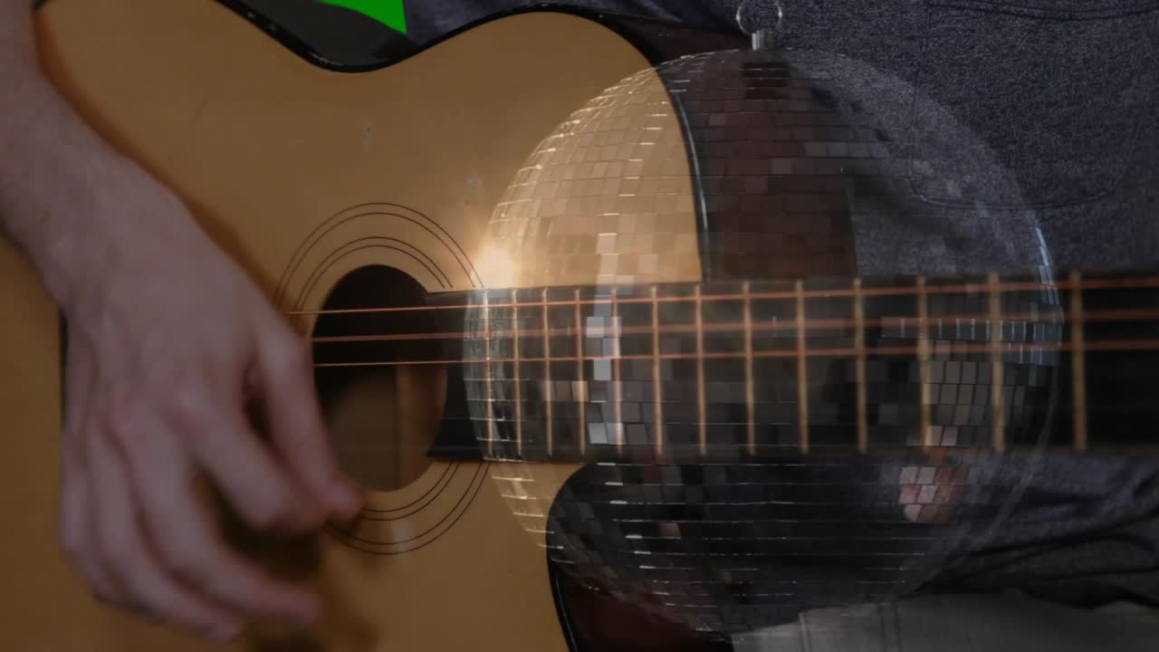 Right hand poised, plucking and strumming guitar strings, mirrored disc shifting, showing technique