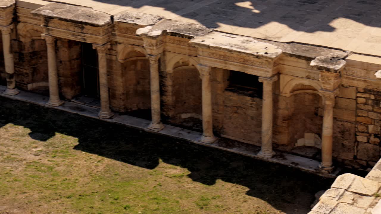 Stunning video of a Roman amphitheater at the ruins of Hierapolis, in Pamukkale, Türkiye. UNESCO world heritage. Video was made on sunny summer day.