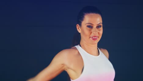 close up of a sexy brunette female dancer in a black studio