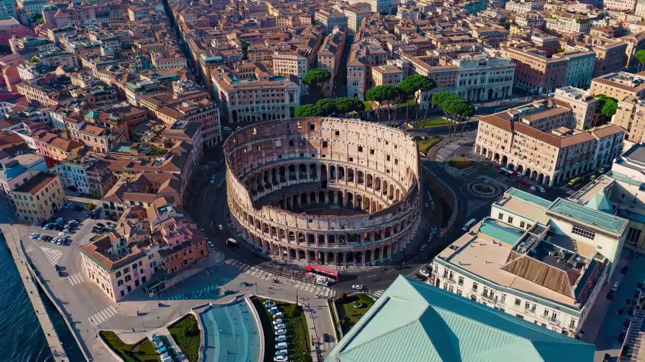 Aerial video showcasing the Colosseum amidst the bustling cityscape of Rome, highlighting ancient