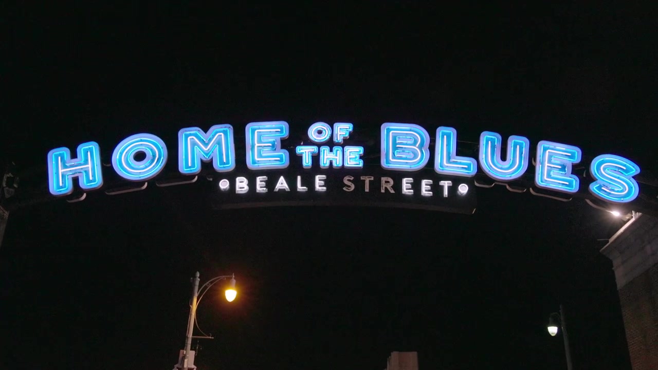 Home of the Blues Beale Street sign in Memphis, Tennessee at night with gimbal video panning left to right.