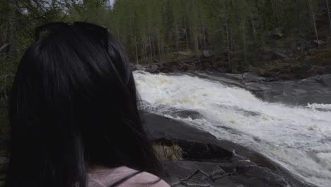 girl looking at waterfall-river. slowmotion