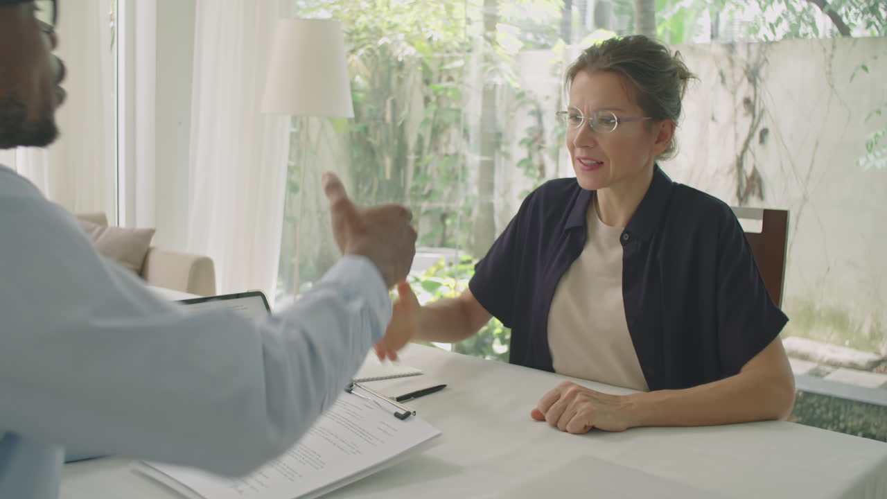 Woman Signing Contract and Shaking Hands with Engineer