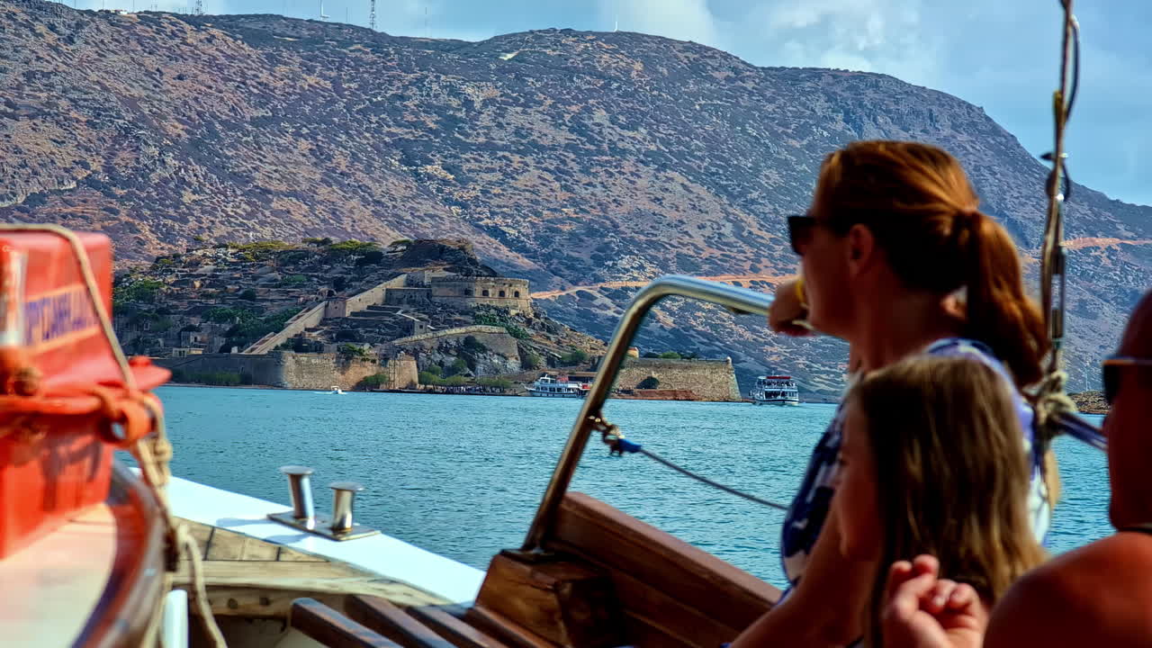 Boat ride Aegean Sea view of Crete island Greece coastline castle walls landmark