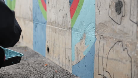 person painting a mural on a wall