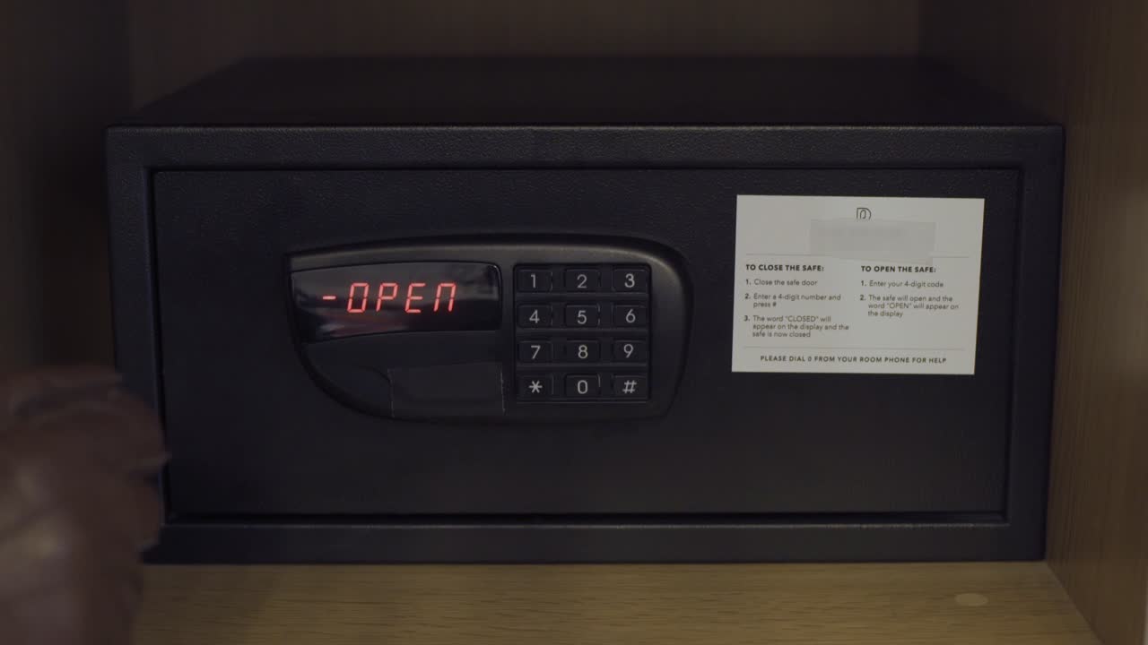 thief opening a safe with a number combination code