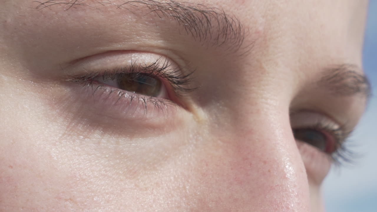 Brown eye without makeup of young woman, close up