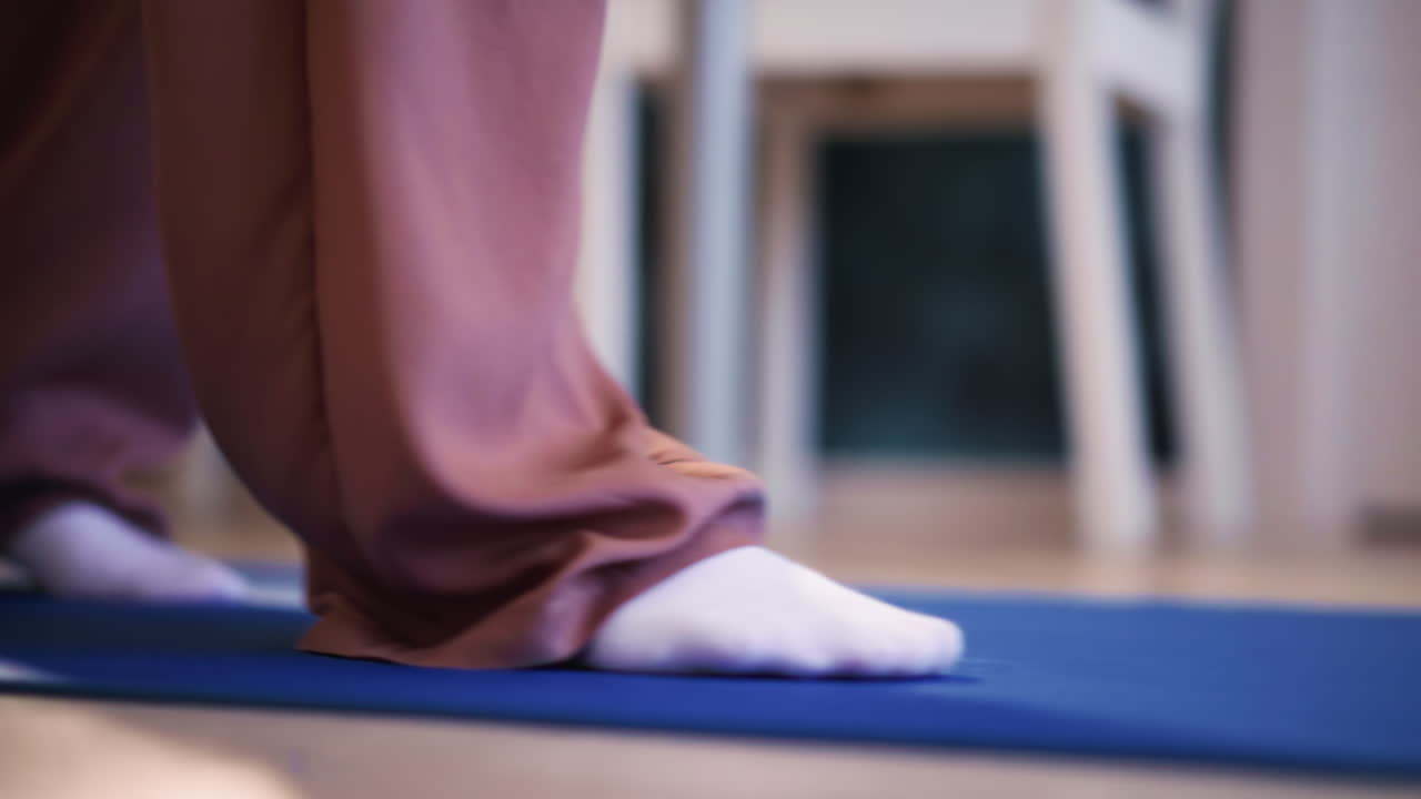 Soft Socked Feet On Blue Mat Showing Gentle Kneeling And Mindful Toe Stretch Yoga Instructor Preparing For Slow Morning Practice, Warm Indoor Light, Calm Rhythm And Grounding Breath For Wellbeing