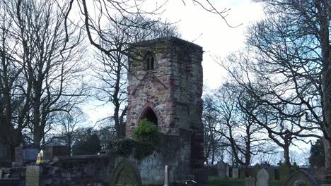 Establishing-shot-across-Windleshaw-Chantry-stonework-tower-exterior-slow-motion-around-ruins-against-blue-sky