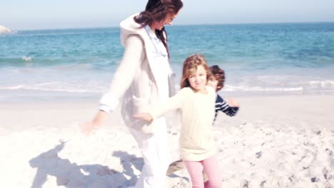 mother and children playing on the beach