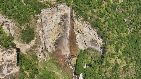 top-down aerial view of seerenbachfälle waterfall cascading down rocky cliffs in amden, switzerland