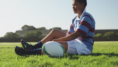 young adult female rugby player on a rugby pitch