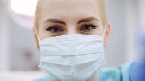 Close-Up-Of-Female-Dentist-Looking-At-Patient-During-Surgey-2