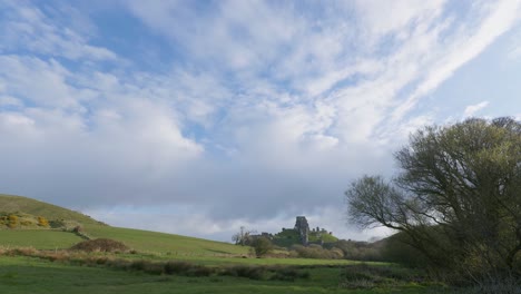 scenic panning shot of corfe castle and the surrounding dorset countryside