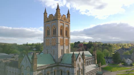 sweeping cinematic shot of a cathedral in buckfast, england during sunset