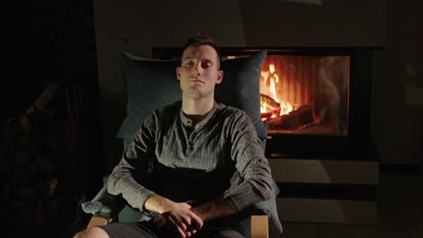 man relaxing by the fireplace