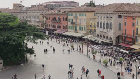 people at piazza bra along the restaurants from verona arena in italy