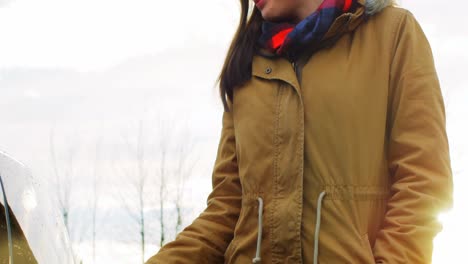 Woman-charging-the-electric-car-on-a-winter-day