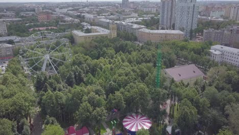 city park aerial view with ferris wheel and amusements