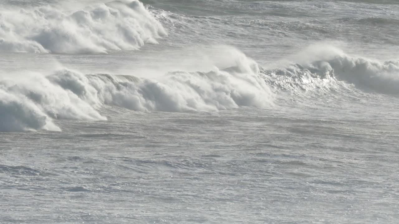 Dynamic ocean waves crash against the shore at Great Ocean Road, Australia, captured in natural lighting with a serene atmosphere