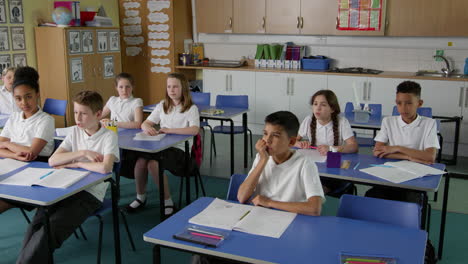 pupils in class with teacher answering question shot on r3d