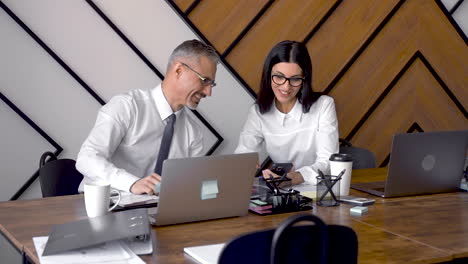 two co workers talking in an office