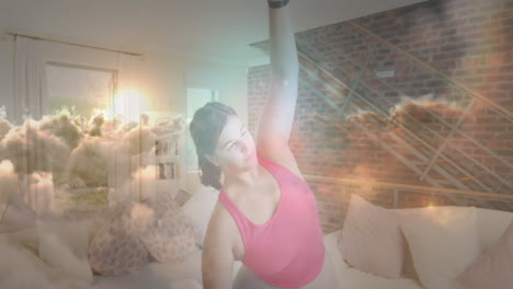 animation of sunset with clouds over woman exercising and stretching at home