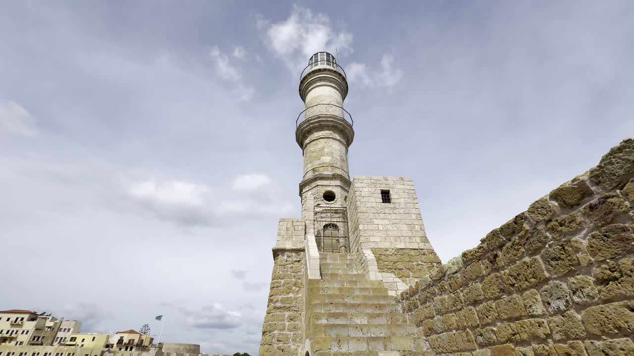A POV walking towards Chania's iconic sandstone 16th century Venetian Lighthouse