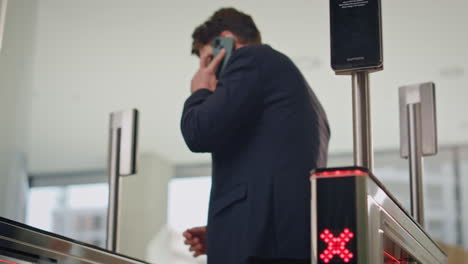 man trying enter office turnstile using smartwatch. calling man unlocking gates