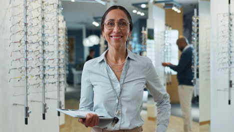 a woman optician smiling in her shop