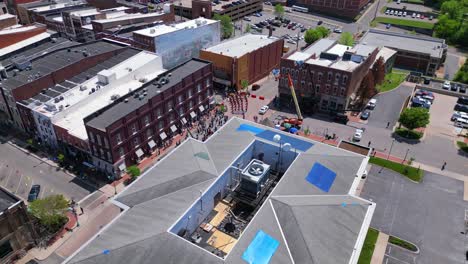 aerial orbit of film equipment, extras, and cast of movie holland michigan on location in downtown clarksville tennessee